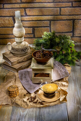 Antique lamp, vintage coffee grinder on wooden background