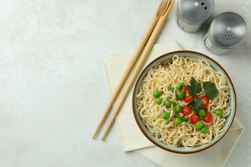 Concept of tasty eating with bowl of noodles on white textured background