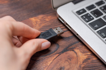 Image of a usb cable plugged into a laptop port. The concept of modern ultra-fast ways of...