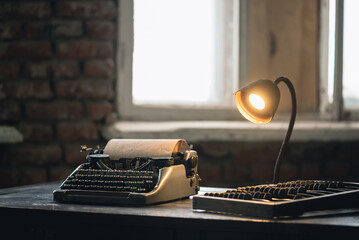 Retro typewriter, old abacus and lamp on the antique desk table background. Writer or accountant...