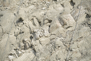 Metal protective mesh on a cliff. Protective grid.