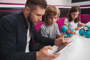 Teacher and pupils during robotics class