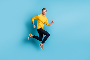 Fototapeta na wymiar Full body profile photo of satisfied person running jumping toothy smile isolated on blue color background