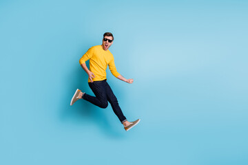 Full body profile photo of handsome man jumping hands playing imagine guitar isolated on blue color background