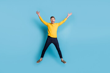Full size portrait of astonished guy jumping high make star figure isolated on blue color background