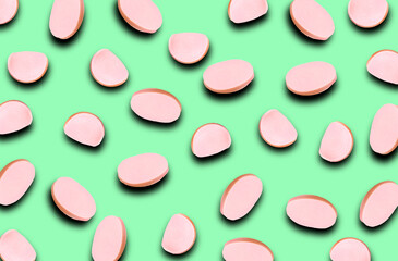 A pattern of different slices of sausage with a shadow on a blue background. Grocery background.