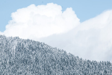 Clouds behind snowy mountain