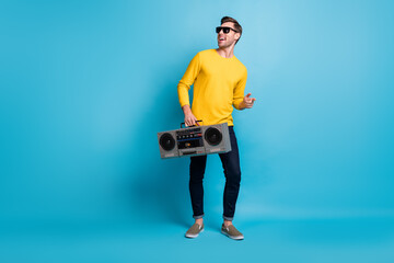 Full length photo of positive person arm carry boom box have fun partying isolated on blue color background