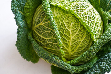 Fresh organic savoy cabbage head isolated on a white background