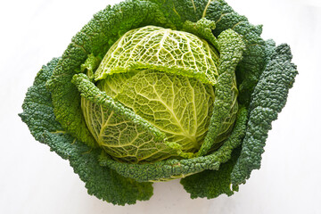 Fototapeta premium Fresh organic savoy cabbage head isolated on a white background