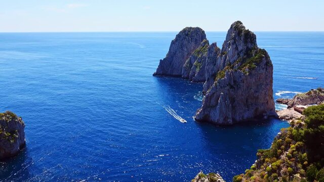 Several powerboats sailing on the sea beside Capri island in southern Gulf of Naples, Italy