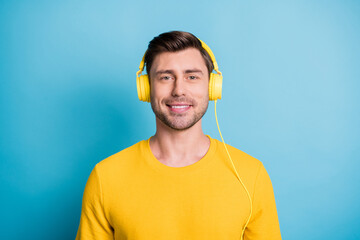 Photo of handsome guy toothy smile headphones on head look camera isolated on blue color background