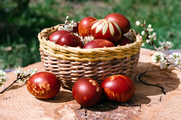 Basket with easter cake and red eggs on rustic wooden table. Concept for Easter, religious holidays. Top view.