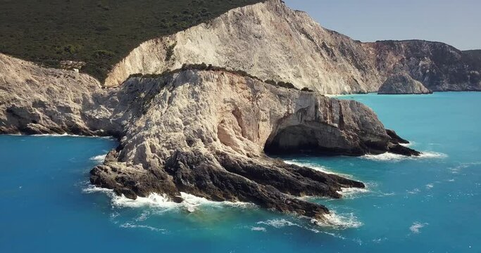Aerial drone video of popular tropical paradise deep turquoise beach of Porto Katsiki with white steep rocky seascape and beautiful cloudy landscape, Lefkada island, Ionian, Greece
