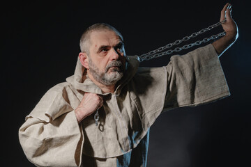 A wandering militant monk practicing a martial art with a chain in his hands