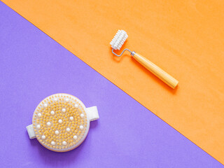 Flat lay of a dry brush and a face roller for beauty and massaging the body. Skin care and relaxing home routine for women. Helps detoxify and exfoliating. Body care products.