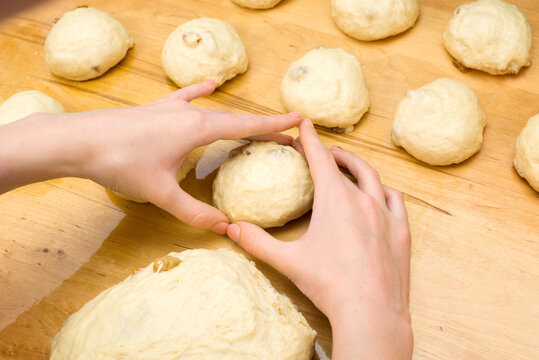 Making dough buns. Women's hands in the shape of a heart. homemade baking
