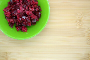 Bright vinaigrette in a bowl on a wooden background.