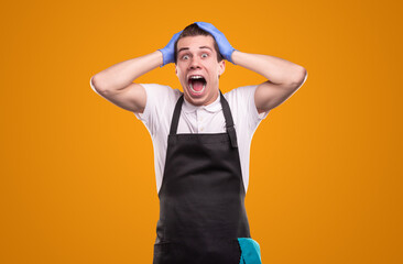 Fototapeta premium Scared male housekeeper screaming and looking at camera
