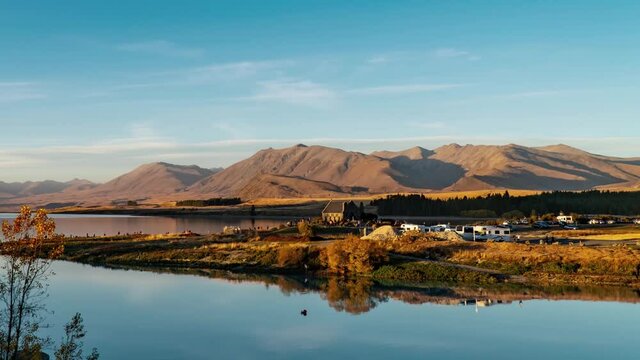 Lake Tekapo in Mackenzie Basin in the South Island of New Zealand, people being busy from morning to night, time lapse of beautiful natural landscape