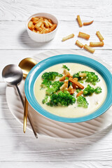 cream soup with broccoli and croutons in a bowl