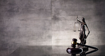 Law and justice concept. Law symbols composition: judge’s gavel and Themis  statue.