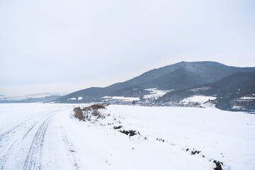 Fototapeta na wymiar Snowy road on a hill