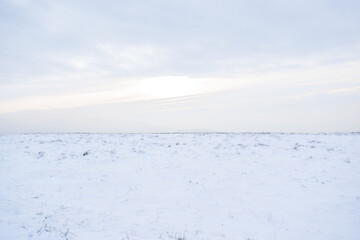 Fototapeta na wymiar Snowy meadow on a hill