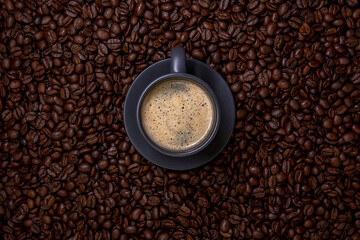 Cup of coffee in coffee beans