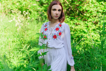 Outdoors portrait of beautiful young woman in the park. Selective focus.