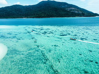 A beach on a clear blue tropical island