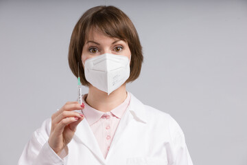 female doctor or nurse with a syringe pulled up with a vaccine