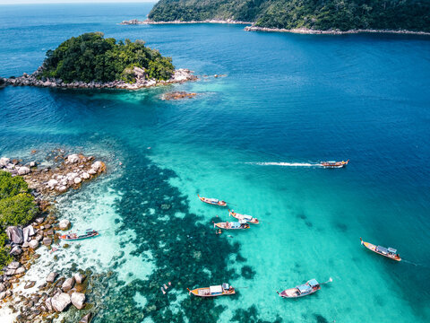 Aerial view of the long tail boats on tropical sea satun, Thailand ,Island and coral © artrachen