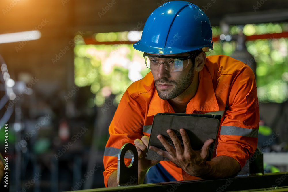 Aufkleber Engineer or factory worker using digital tablet checking inspecting metal component at machine in factory.