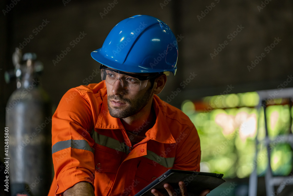 Poster engineer uses tablet checking production process in the industry workplace factory.