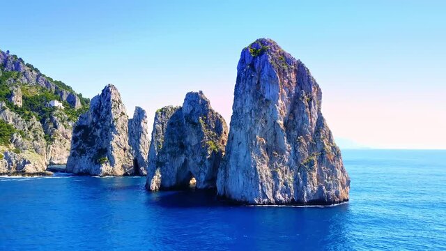 Orbiting shot of the three famous Faraglioni rocks off the Capri island, well-known all over the world