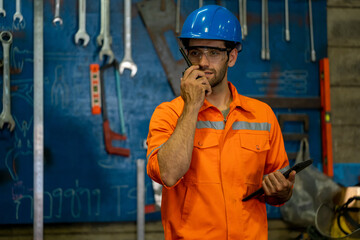 Technician engineer use radio to communicate assign in the factory.