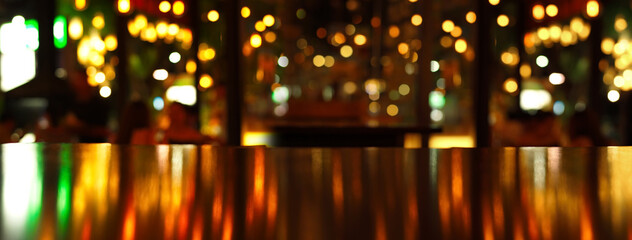 reflection of party light on wood table in pub or bar in Christmas night banner background