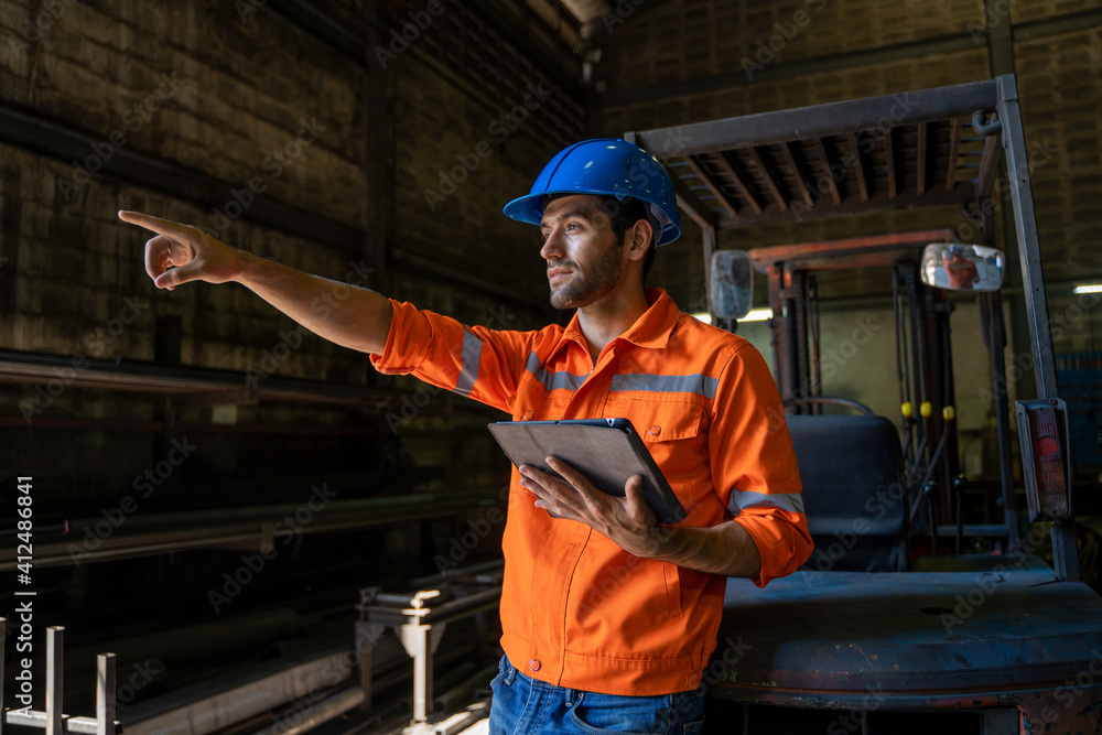 Poster engineer uses tablet checking production process in the industry workplace factory.