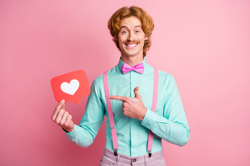 Photo of young funky funny smiling cheerful positive happy man point finger at heart icon isolated...