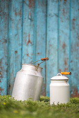 Milk cans over wooden rustic background