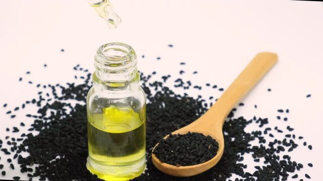 essential oil of black cumin in small bottles. selective focus.