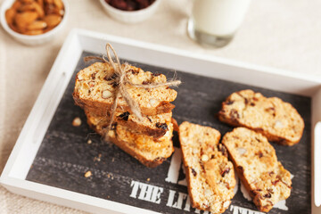 Sliced banana nut bread. Cake with nuts on wooden board. Morning breakfast background. Baked home desert. Close up view.