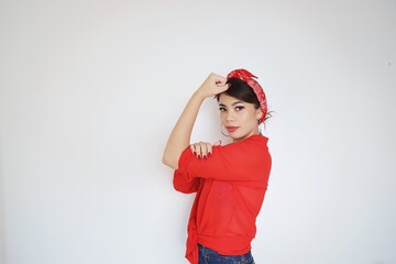 Portrait beautiful woman in red shirt showing her bicep,We can do it,Woman’s day concept.