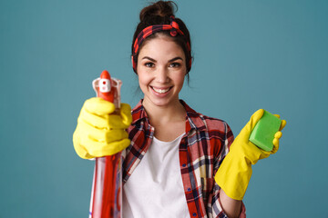 Happy woman in gloves smiling and showing cleaning product