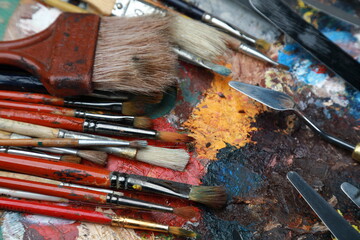 brushes, paints and palette, all for creativity