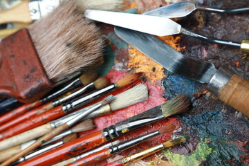 brushes, paints and palette, all for creativity