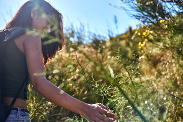 A serene young lady walking through nature