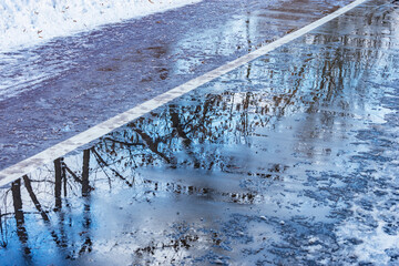 Wet asphalt road surface at winter morning.