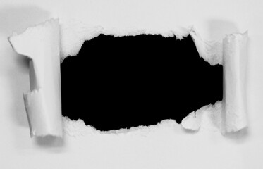 Ripped hole paper isolated on black background